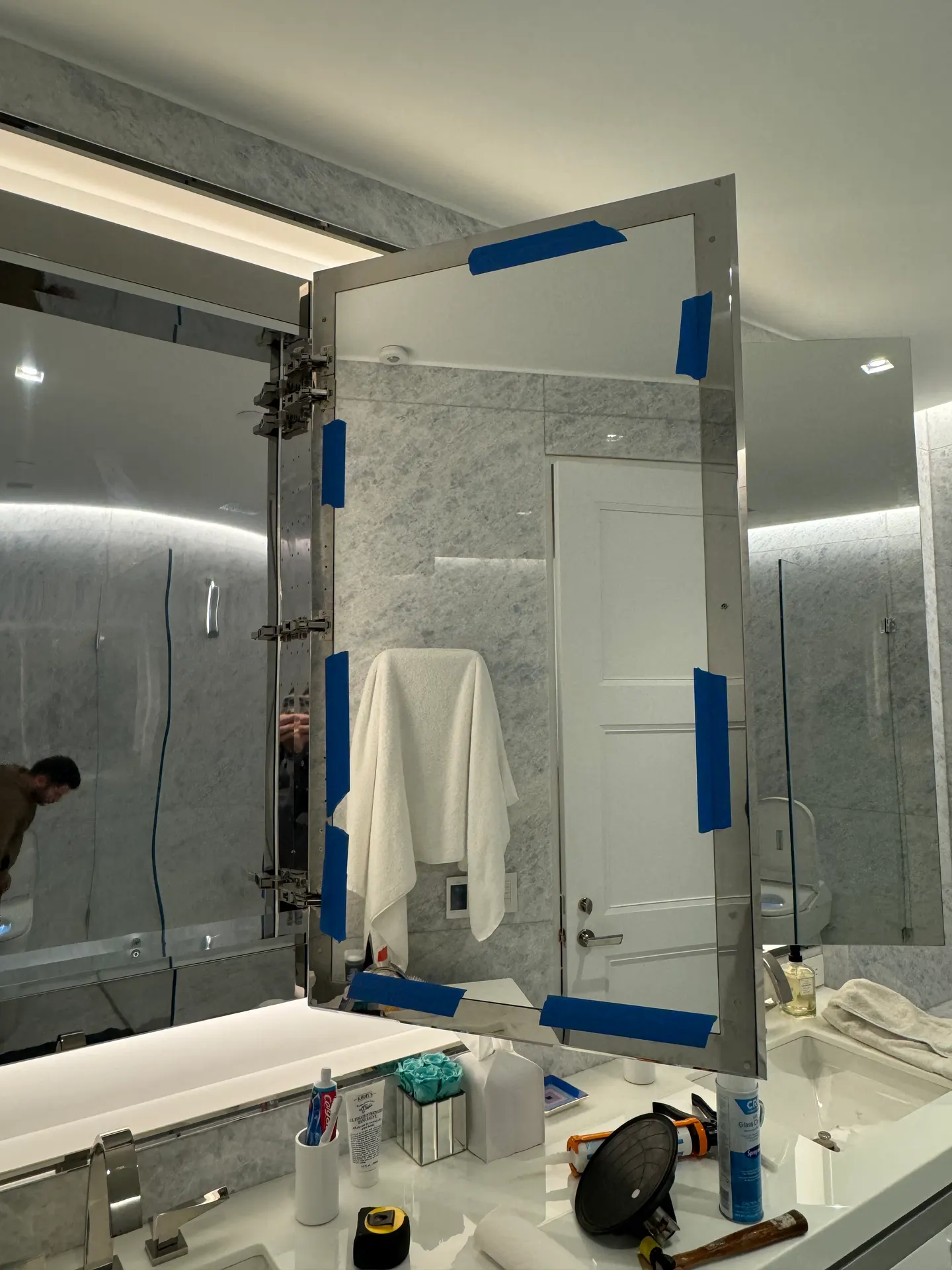 Work in progress on a mirrored bathroom cabinet door
