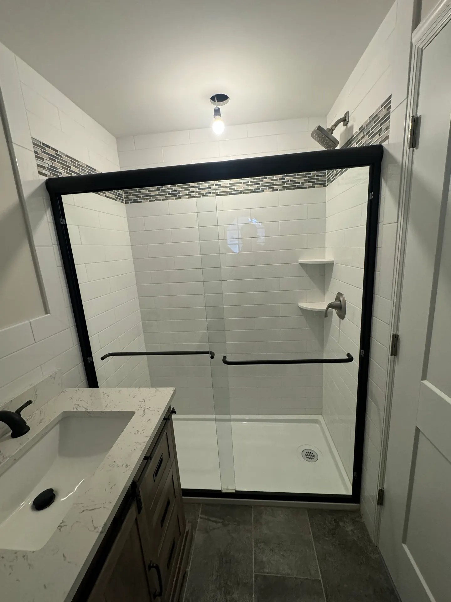 Frameless shower door with brushed nickel hardware