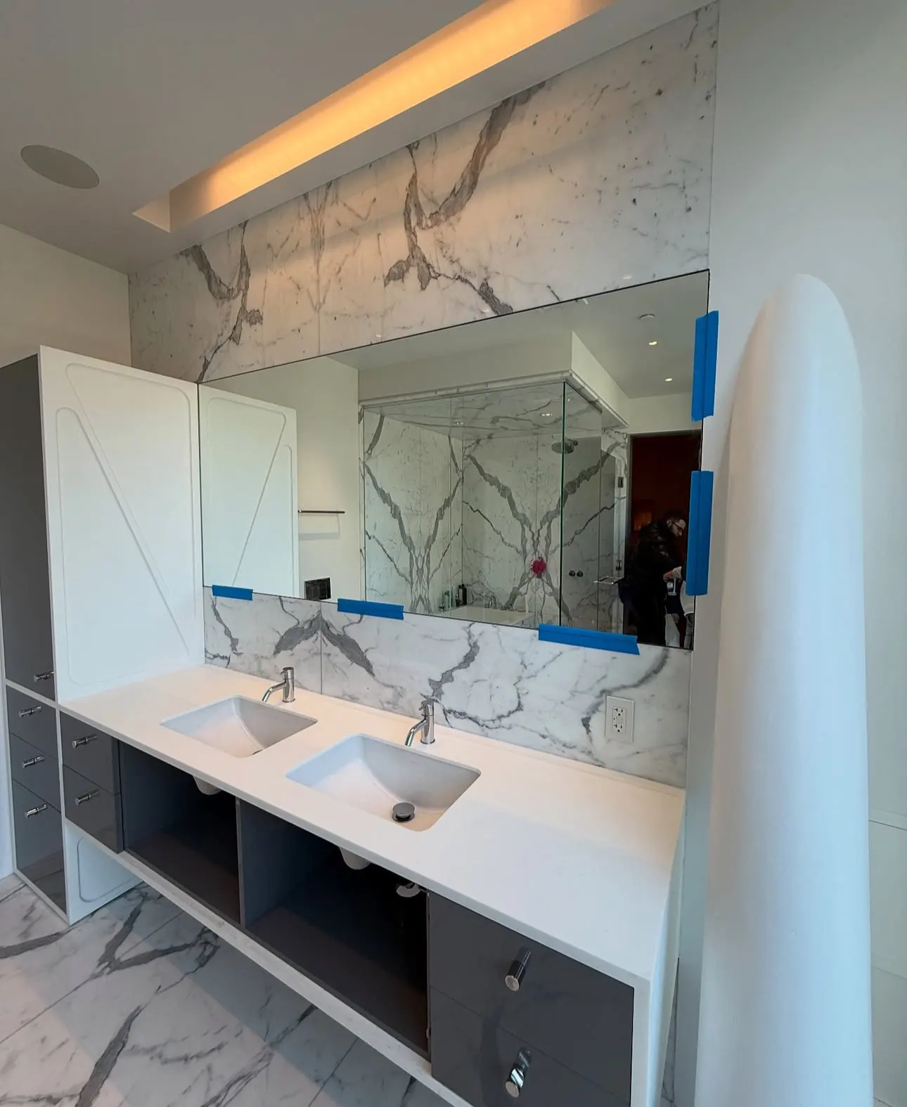 Glass shower door being fitted during installation