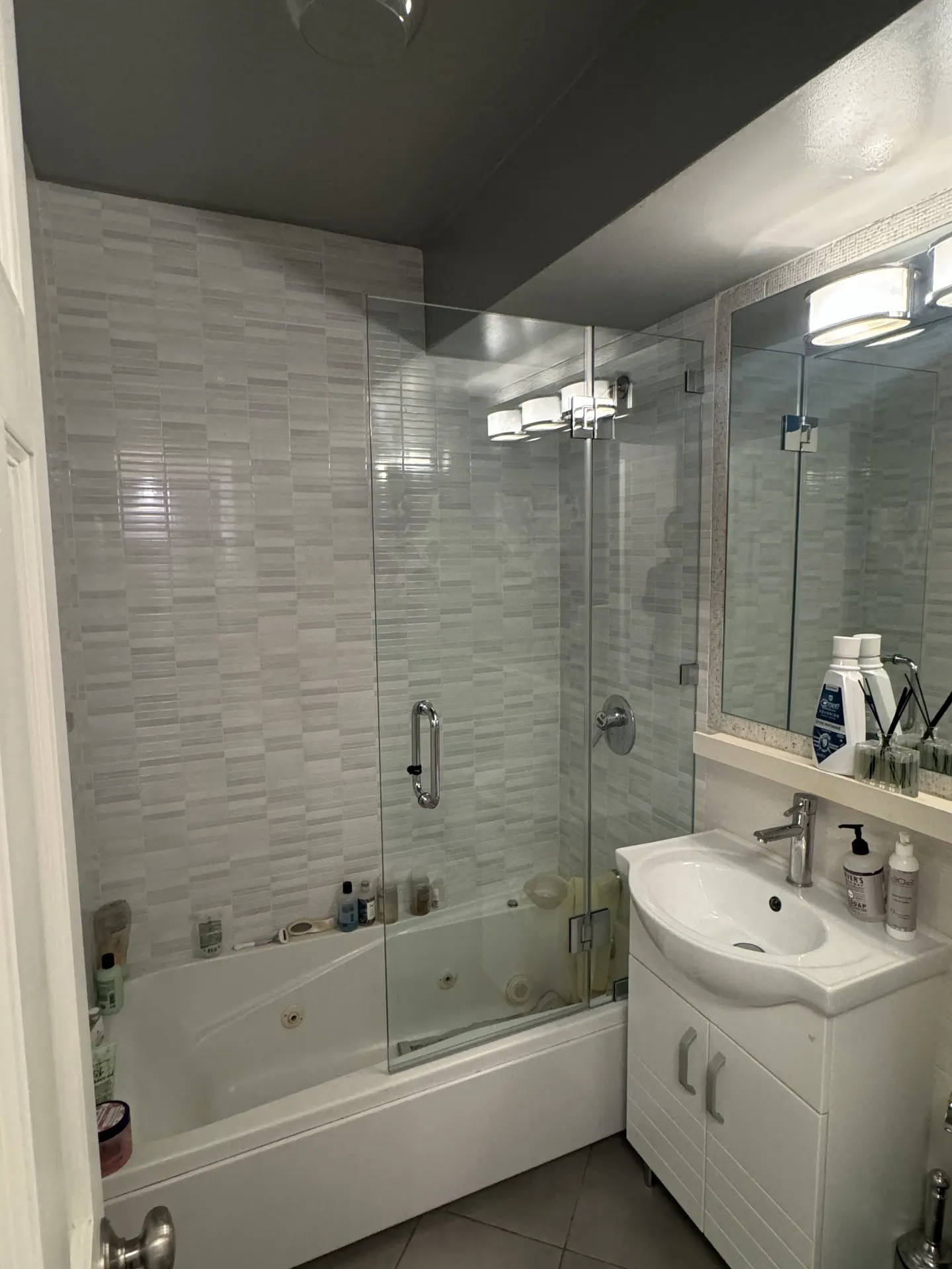 Frameless shower door with chrome hardware and towel bar