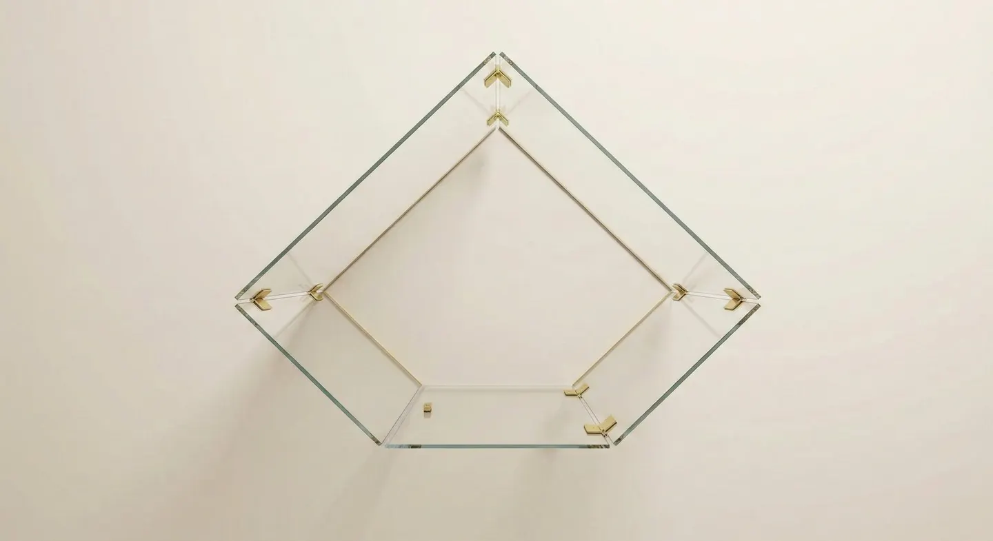 Neo-angle frameless glass shower enclosure with five glass panels and brass clamps — overhead view showing pentagonal geometry
